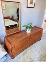 Front view of teak dresser with mounted mirror