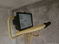 Overall view of work light on carpet showing handle, housing and cord