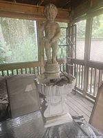 Full view of fountain showing boy statue, basin and pedestal