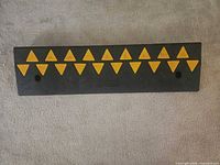 Top view of ramp showing yellow triangles on black rubber