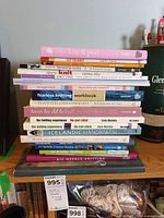 Full stack of knitting books on shelf