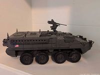 Left side view of the gray eight-wheel armored vehicle model with USA flag decal