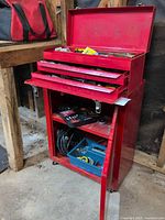 Overall view of red Mastercraft rolling chest with top box open and lower cabinet, tools visible on shelves