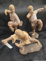 Front view of three martial arts figurines