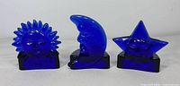 Front view of all three cobalt blue glass candleholders