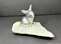 Front view of aluminum rabbit on stone base