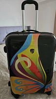 Front view of Heys Britto Butterfly spinner suitcase showing design, handle and wheels