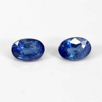 Two oval-cut blue sapphires displayed side by side