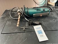 Makita right-angle drill with cord, drill bit, and chuck key