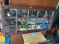Front view showing mirror panes in wooden frame