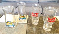 All four hurricane glasses showing both logo styles