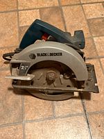Left side view showing blade guard, horsepower label and logo