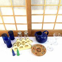 Group shot showing all items: pottery holders, glasses, pitcher, vases, shakers, wood plate
