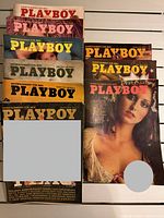 Nine stacked Playboy magazines showing various 1974-1976 covers