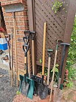 Group of garden tools leaning against wall