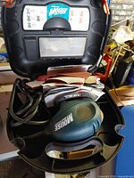 Black & Decker Mouse sander in open carry case with sanding pads visible
