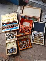 Overview of all six boxed router and boring bit sets laid out