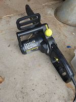Left side view of Yardworks chainsaw body, showing motor housing and tension knob