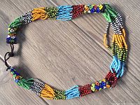 Full view of multicolour beaded necklace laid flat
