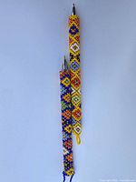 Two beaded pens side by side on white background