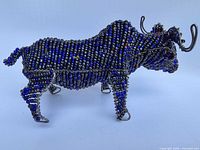 Right side profile of beaded wire water buffalo figurine