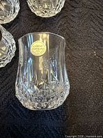 Close-up of one glass showing Cristal d'Arques sticker and cut pattern