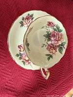 Paragon cabbage rose tea cup and saucer with pale yellow interior, floral decoration, gold trim