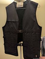 Front full view of 1017 ALYX 9SM black tactical vest on hanger