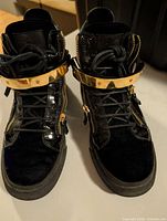 Top view showing lace-up fronts, gold strap, velvet toe boxes