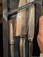 Retail box showing two large knives and one small paring knife of Global Cromova 18 line
