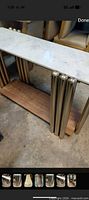 Full view of console table showing marble top, chrome legs, wood shelf