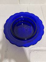 Top view of cobalt blue pressed glass bowl showing scalloped rim