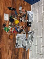 Full lot spread on tabletop showing all keychains, keys, tools and sealed fob covers