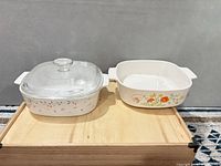 Both casserole dishes side by side on wood surface