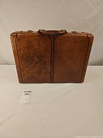 Front view of brown leather hard-sided briefcase