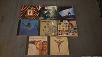 All eight CD fronts displayed on table