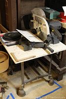 Full side view of Craftsman 10 inch compound miter saw mounted on stand table, showing general condition and setup.