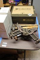 Photo of lot showing Stanley No 400 picture frame vise, hammers, and hand drill on a table with some boxes