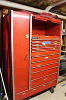 Front view of red Snap-on tool chest showing 14 drawers and flip-up top compartment