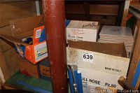 Boxes containing various ceramic tiles including box labeled Made in Italy with bull nose tiles and boxes marked for upstairs bathroom