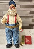 Front view of Santa figurine with booklet
