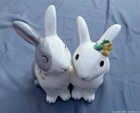 Front view of glazed ceramic bunny figurine pair