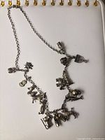 Full view of necklace showing chain length and distribution of charms