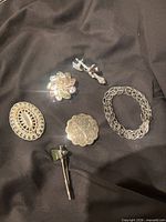 All six jewelry pieces arranged on black fabric