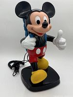 Front view full telephone showing Mickey figure, handset, cord and base