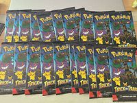 Array of sealed Pokémon Trick or Trade booster packs spread out