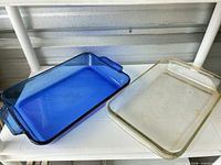 Blue Anchor Hocking and clear Pyrex baking dishes side by side