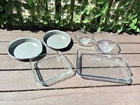 All six items: two glass bowls, square and rectangular glass dishes, two metal cake pans