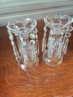 Pair of clear glass candlesticks with hanging crystal prisms