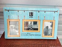 Front of sealed Umbra Trapeze Wood hanging photo display box